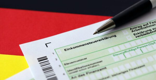 German annual income tax return declaration form with pen on flag close up